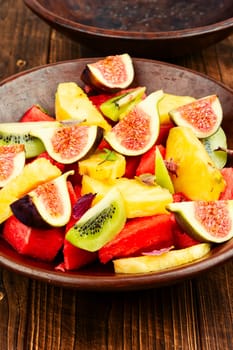Fruit salad with pineapple, watermelon, kiwi and figs.