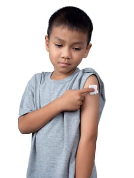 Little asian child boy wearing short-sleeve shirt with bandage plaster on her arm after vaccination for boost immunity. Injection covid vaccine, Tetanus vaccine, Flu vaccine, healthcare for children.