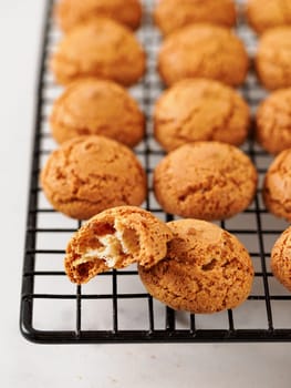 Amaretti cookie on cooling rack - traditional Italian Sardinian pastry. Delicious amaretti biscuit cookies made from almond or apricot kernels with copy space
