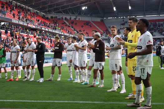 The players of newly promoted FC St. Pauli are celebrated by their own fans after the 0:3 victory in Freiburg after the match of the 1st FBL: 24-25: 1. FBL: 24-25: 5. Sptg. SC Freiburg - FC St. Pauli  DFL REGULATIONS PROHIBIT ANY USE OF PHOTOGRAPHS AS IMAGE SEQUENCES AND/OR QUASI-VIDEONann  Photo: Joachim Hahne/johapress