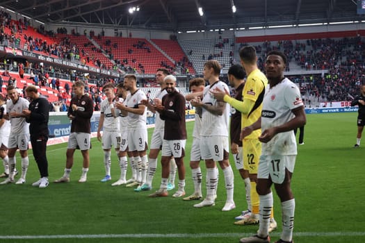 The players of newly promoted FC St. Pauli are celebrated by their own fans after the 0:3 victory in Freiburg after the match of the 1st FBL: 24-25: 1. FBL: 24-25: 5. Sptg. SC Freiburg - FC St. Pauli  DFL REGULATIONS PROHIBIT ANY USE OF PHOTOGRAPHS AS IMAGE SEQUENCES AND/OR QUASI-VIDEONann  Photo: Joachim Hahne/johapress