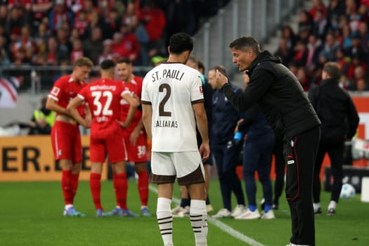 In a break in play,coach Alexander Blessin (FC St. Pauli) gives instructions to Manolis Saliakas (FC St. Pauli) in the match of the 1st FBL: 24-25: 1st FBL: 24-25: 5th Sptg. SC Freiburg - FC St. Pauli  DFL REGULATIONS PROHIBIT ANY USE OF PHOTOGRAPHS AS IMAGE SEQUENCES AND/OR QUASI-VIDEONann  Photo: Joachim Hahne/johapress