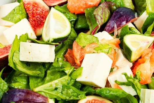 Vitamin salad with figs, greens and cheese. Close up.