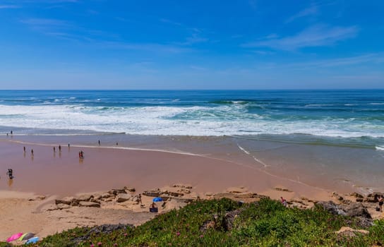 Sintra, Portugal: April 13, 2024: People at the beach of Ericeira, Mafra, Portugal