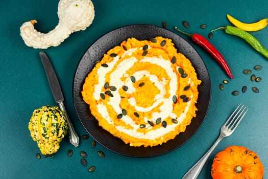 Risotto with pumpkin on a table. Rustic style. Vegan pumpkin risotto with pumpkin seeds. Autumn food