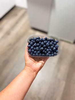 Fresh blueberries on box close-up, background.