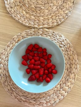 Red raspberry berry in plate on table top view. Fruit berries background. Summer food background