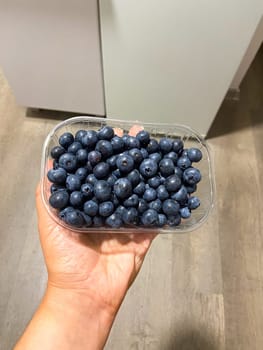 Fresh blueberries on box close-up, background.