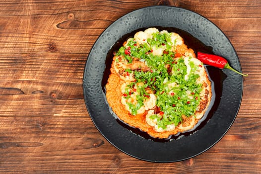 Baked spicy cauliflower with yogurt sauce. Fried cauliflower. Space for text.