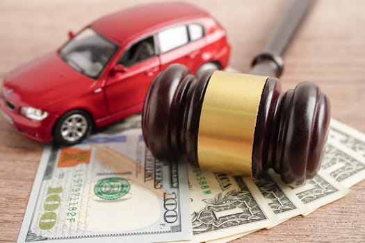 Car accident lawsuit and insurance, Judge hammer and money with car model.