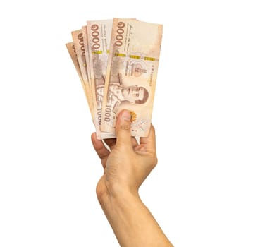 Thai baht banknotes cash money in woman hand isolated on white background with clipping path.