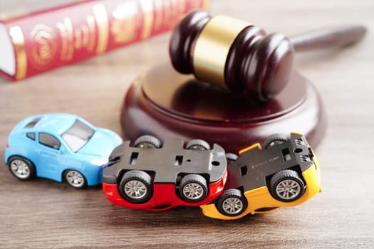 Bangkok, Thailand March 15, 2023 Car accident lawsuit and insurance, Judge hammer with car model.