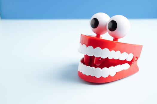 Funny red teeth with eye toy denture model for dental health care.