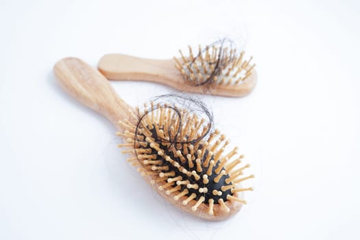 Hair loss fall with comb brush isolated on white background.