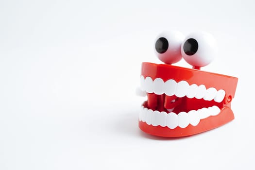 Funny red teeth with eye toy denture model for dental health care.