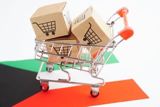 Online shopping, Shopping cart box on Kuwait flag, import export, finance commerce.