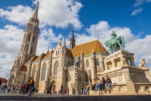Budapest, Hungary- September 25 2024: Matthias gothic church in Budapest, with its colorful roof tiles atop Castle Hill, visited by tourists