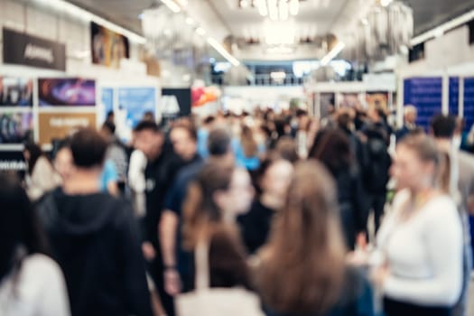 Abstract blurred people at exhibition hall of expo event trade show. Business convention show or job fair. Business concept background.
