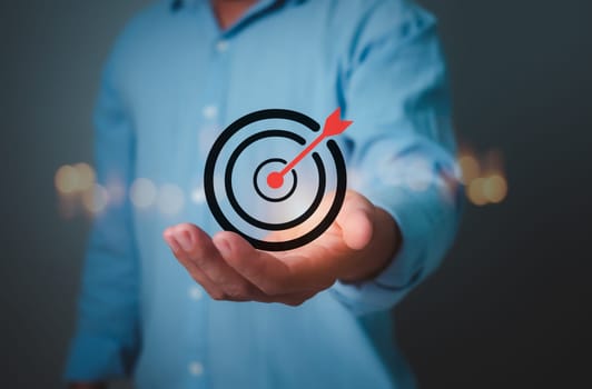 Man hold virtual target icons for business objective, Targeting business concept, Strategic planning for business growth and target customer group, Set up business objective target goal.