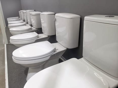New modern toilet in the plumbing store. Samples of modern sanitary ware for the toilet