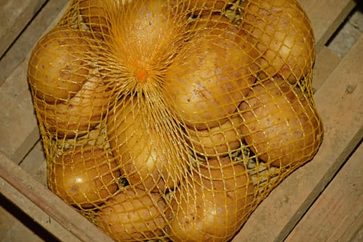 potatos in a net in a cellar