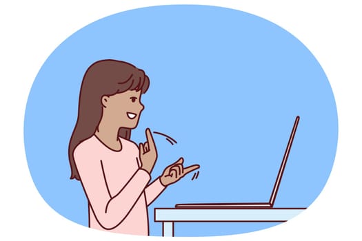 Silent teenage girl using laptop and sign language making video call to friends or school teacher for distance learning. Silent child gesturing standing near computer while learning to communicate