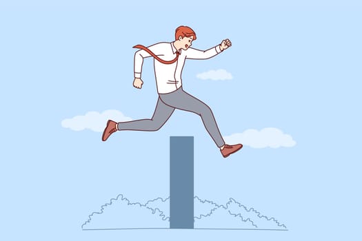 Ambitious business man overcomes obstacle on path to success by jumping over high wall. Successful businessman overcomes obstacles thanks to professional experience and motivation.