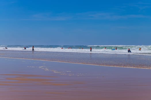Ericeira, Portugal: April 13, 2024: Group of surfers with surfboards going to surfing. Ericeira is the famous surfing destination in Portugal.
