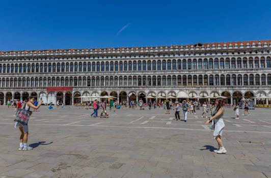 Venice, Italy - July 26, 2024: Asian tourists standing on San Marco square. Venice is very popular tourist destination. Venice, Italy