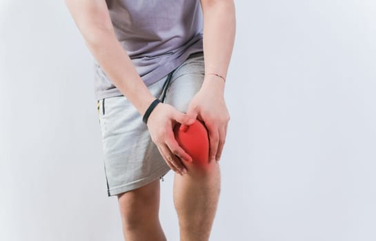 Person with knee pain isolated. Medical problem of knee pain. Sore man with knee pain isolated