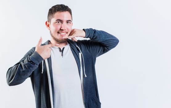 Person gesturing CALL ME in sign language isolated. Handsome young man gesturing CALL ME on isolated background