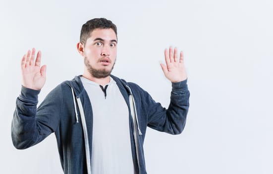 Scared man with raised hands isolated. Person with scared face with raised hands