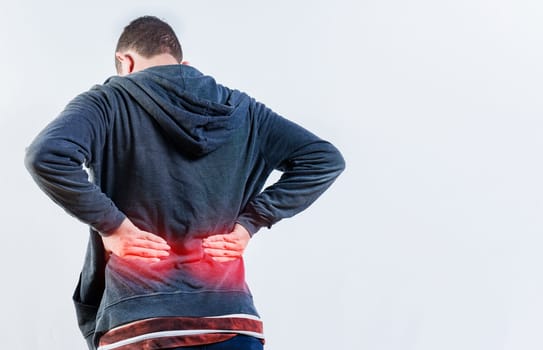 Back view of person with back ache isolated. Lumbar problems concept. Male person with spine problems isolated
