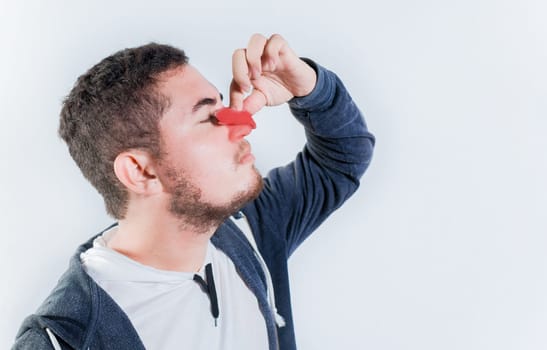 Concept of nasal congestion and nosebleed. Person with nosebleed isolated