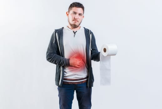 Person with diarrhea and stomach problems holding toilet paper. Man suffering with stomach pain holding roll of paper isolated