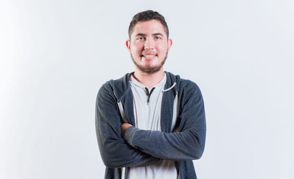 Portrait of handsome latin young man with crossed arms isolated