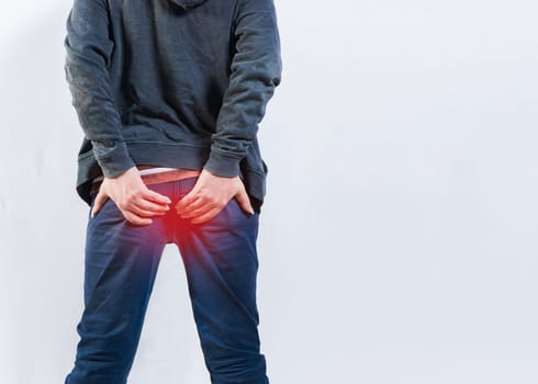 Person with hemorrhoid problem isolated. Unrecognizable man with hemorrhoids and constipation problems