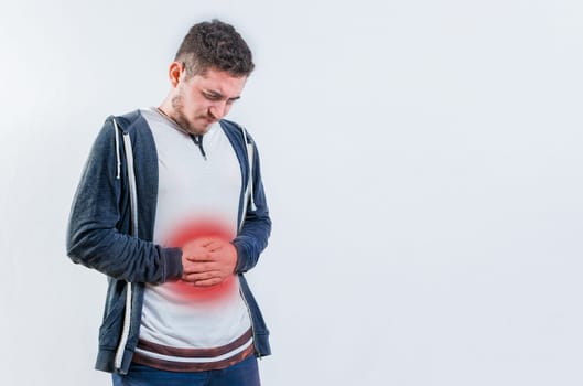 Unhappy man with digestive problems isolated. Person with digestive and stomach problems isolated