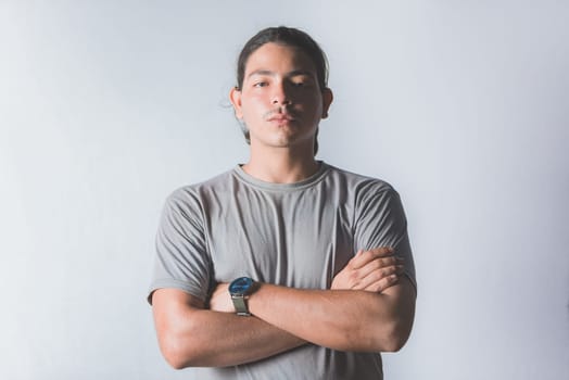 Portrait of handsome latin guy with crossed arms on isolated background