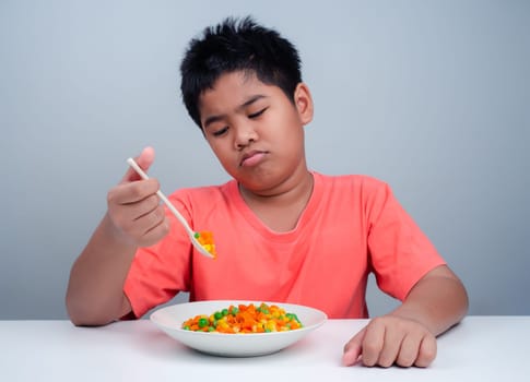 Children do not like to eat vegetables, Little cute boy refuses to eat healthy vegetables, Nutrition healthy eating habits for kids concept, Children do not like to eat vegetables.