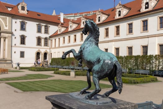 Prague, Czech Republic - September 3, 2024: Wallenstein Palace (Valdstejnska Zahrada) and Wallenstein Garden with  Fountain of Hercules (Herkulova fontana). Prague Castle on Hradcany in background