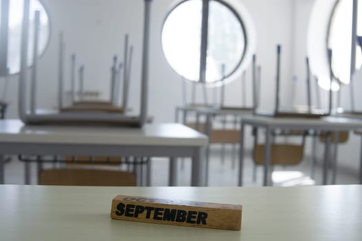 empty school classroom with the word september on the chair