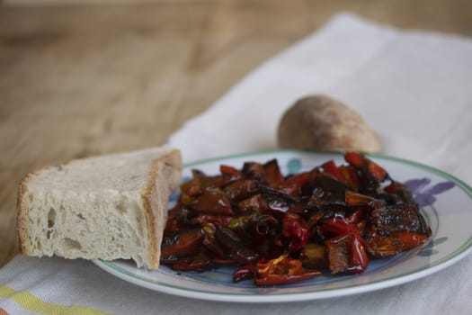 fried peppers with near a slice of bread