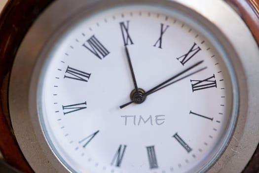 the dial of an old watch with the time written
