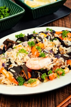 Traditional Chinese food, fried rice with shrimp and mushrooms.