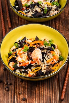 Traditional Chinese food, fried rice with shrimp and mushrooms.