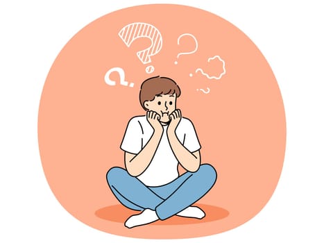 Thoughtful boy sits with sad face and questions above head, thinking about how to spend holidays. Teenager child is trying to remember forgotten information, or to find answers to questions.