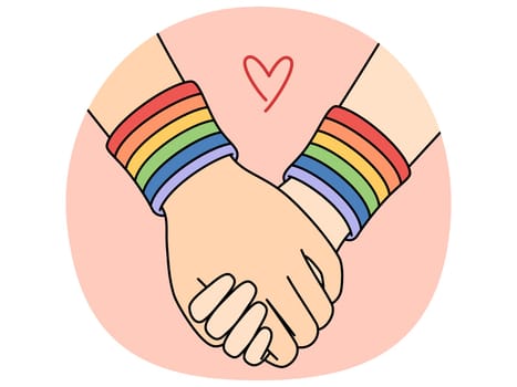 Holding hands with LGBT bracelets symbolizing love between gays or lesbians or tolerance towards LGBTQ community. Concept of sexual freedom and protection of rights of LGBT people in month of pride