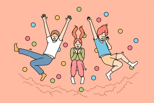 Children jump in pool with balls, laughing and enjoying opportunity to frolic with friends from primary school. Pool with balls in amusement park with little boys and girls diving from great height