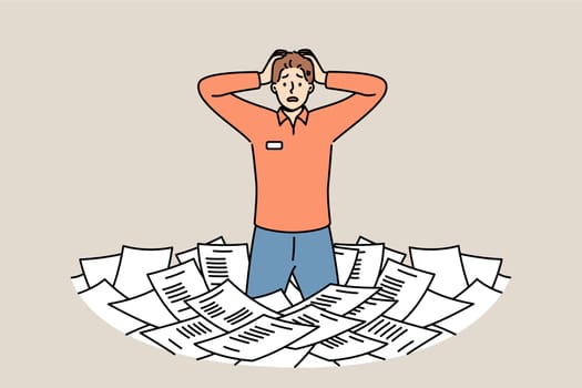 Paperwork and bureaucracy frighten man standing among pile of paper documents and clutching head. Problem of overabundance of paperwork for puzzled clerk or civil service employee.